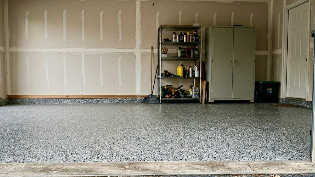 Same garage after full-flake epoxy coating — seamless showroom finish